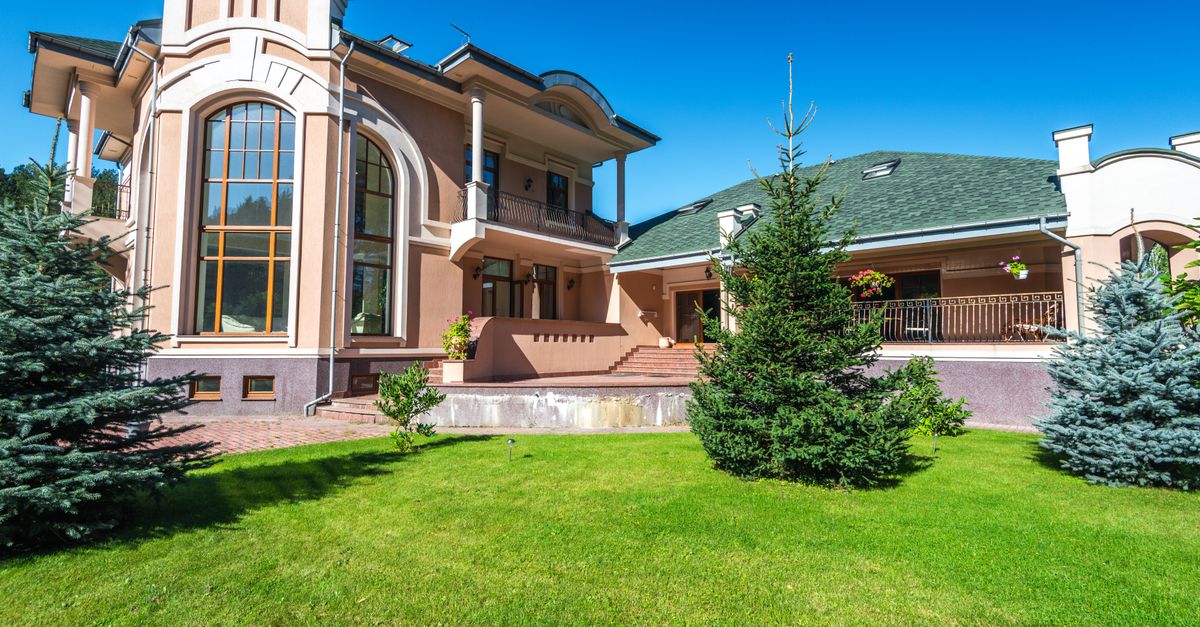 Beautiful residential lawn with lush green grass and mature trees in a suburban neighborhood